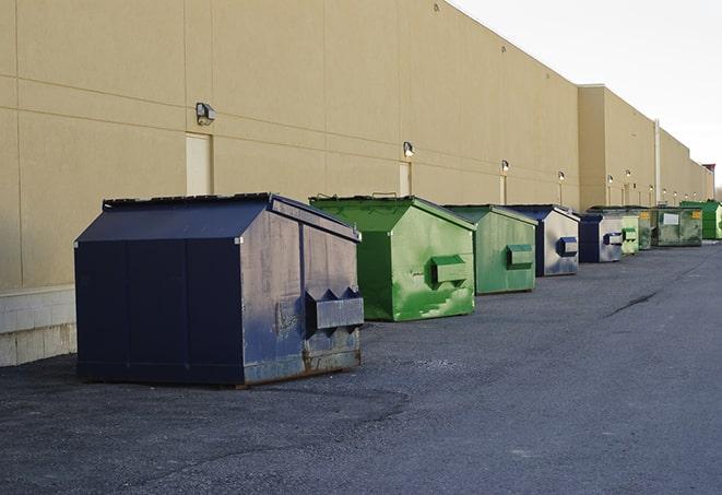 a collection of bright and vibrant dumpsters in a construction zone in Alpine