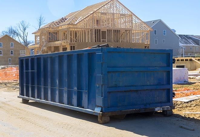 a residential dumpster with the lid open and bags of garbage spilling out